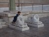 Un gamin grec s'amuse sur un petit lion près de l'entrée de la cathédrale.